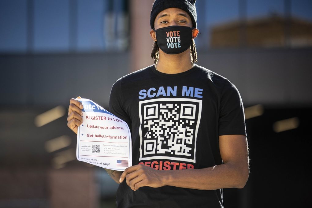 Washington’s Hameir Wright joined teammates on the mens and women’s basketball teams walking campus Monday looking to sign up voters.
(Dean Rutz / The Seattle Times)