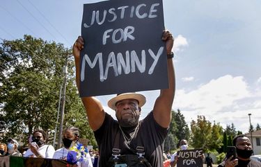 Hundreds of people, including Alvin Burns, center, participate in ‘Manny’s Walk’ in Tacoma, Wash. Friday, July 10, 2020. The event was organized and planned by Manuel Ellis’ sister Monet Carter-Mixon and supported by the Tacoma Action Collective. 214467 214467