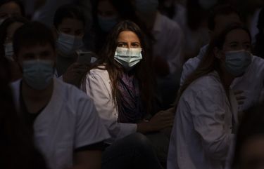 Medical residents sit in the middle of an avenue as they take part in a protest against their working conditions during a strike in Barcelona, Spain, Monday, Sept. 28, 2020. (AP Photo/Emilio Morenatti) EM106 EM106