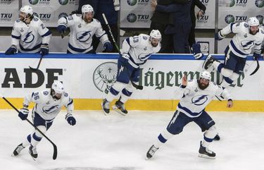 Tampa Bay Lightning players celebrate after defeating the Dallas Stars to win the Stanley Cup in Edmonton, Alberta, on Monday, Sept. 28, 2020. (Jason Franson/The Canadian Press via AP) EDM145 EDM145