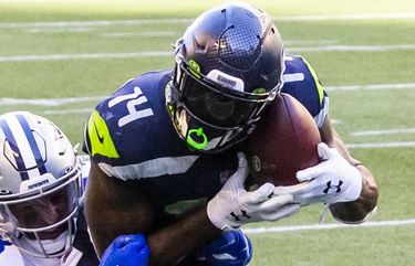 Seattle Seahawks quarterback Russell Wilson (3) greets wide receiver DK  Metcalf (14) during warmups before an NFL football game against the Tennessee  Titans, Sunday, Sept. 19, 2021, in Seattle. (AP Photo/John Froschauer