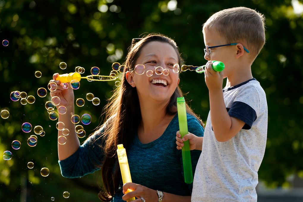 Claire Reagan plays with her son Evan, 5, on Monday in Olathe, Kan. (AP Photo/Charlie Riedel)