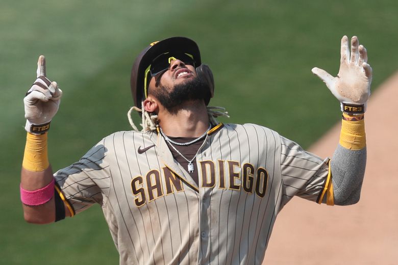 San Diego Padres' Fernando Tatis Jr., right, celebrates with Manny