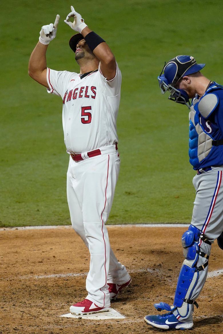 Los Angeles Angels Albert Pujols gets some driving help from his