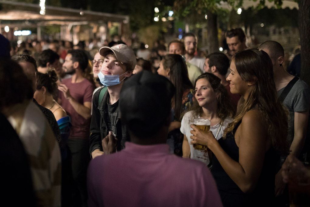 People gather at a bar in Marseille, southern France, Saturday, Sept. 12, 2020. French Prime Minister Jean Castex announced on Thursday a vast extension of the nightly curfew that is intended to curb the spiraling spread of the coronavirus, saying “the second wave is here.” (AP Photo/Daniel Cole)