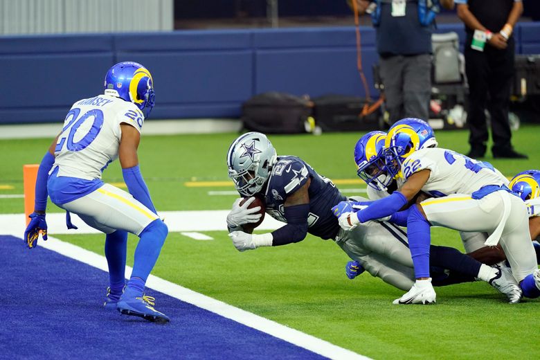 Los Angeles Rams linebacker Troy Reeder, back, tackles Dallas