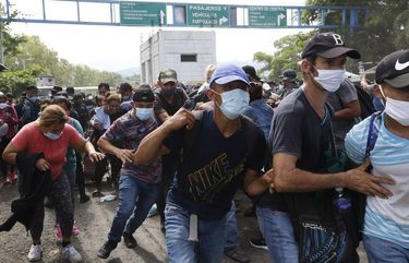 Migrants attempt to cross the border from Corinto, Honduras, into Corinto, Guatemala, Thursday, Oct. 1, 2020. Hundreds of migrants walked from San Pedro Sula, Honduras to the Guatemala border, testing a well-trod migration route now in times of the new coronavirus. (AP Photo) HND103 HND103