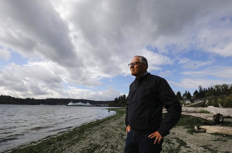 Gov. Jay Inslee is seeking a third consecutive term.  Known as the “green governor” for his climate change positions, he’s on a Bainbridge Island beach.  He has a home on the island. (Alan Berner / The Seattle Times)