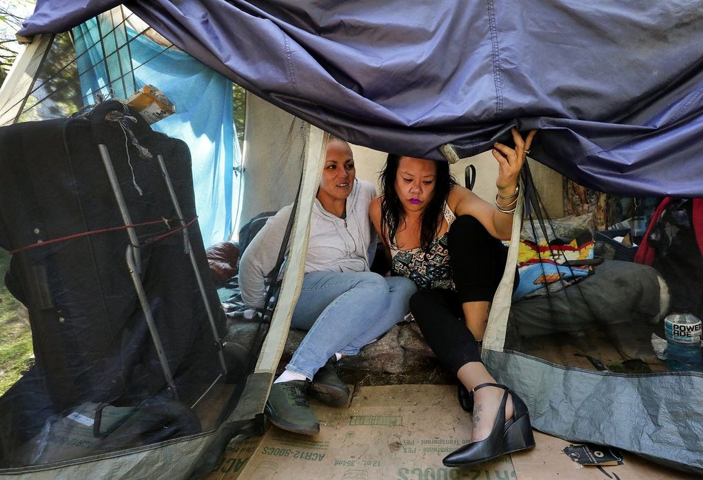 Manaia Muńoz left, and April Palileo say
the Denny Park encampment is peaceful and friendly. Friends, both are working toward getting apartments or some permanent housing. (Alan Berner / The Seattle Times)