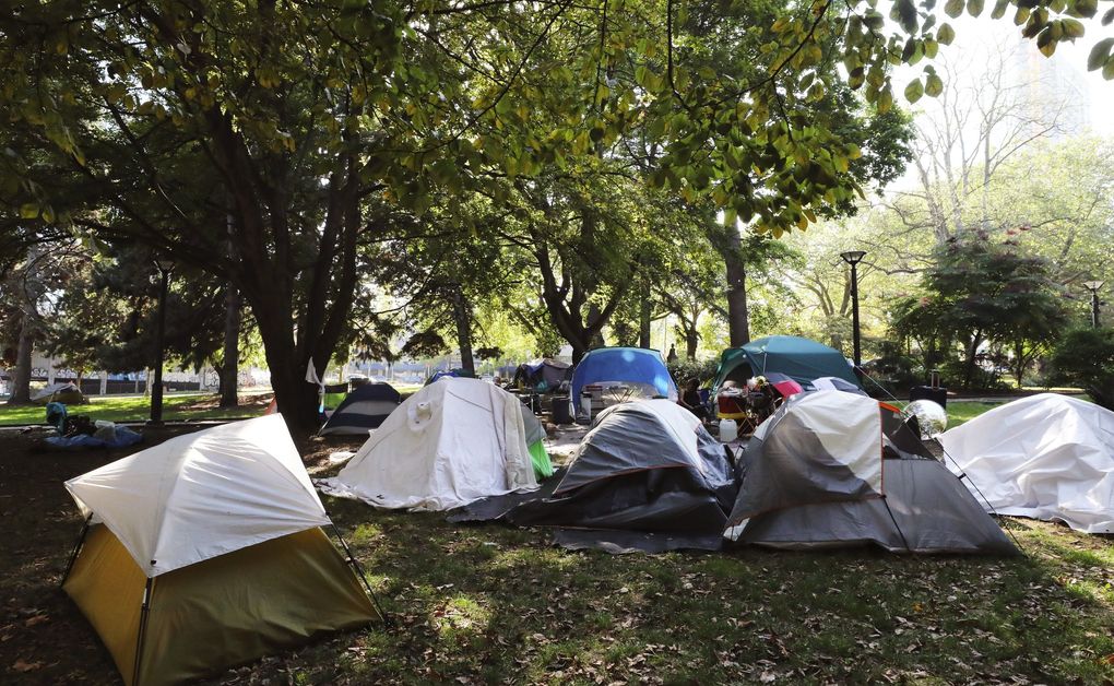 Dozens of tents are at the Denny Park encampment, considered relatively safe by residents, though thefts have occurred. It’s also a pretty clean site and is next to Seattle Parks and Recreation’s headquarters. (Alan Berner / The Seattle Times)
