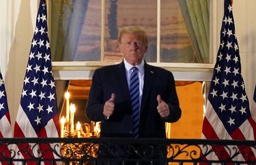 President Donald Trump stands on the Truman Balcony upon returning to the White House Monday, Oct. 5, 2020, after testing positive for COVID-19 and spending four days at the the Walter Reed Medical Center in Bethesda, Md. (Anna Moneymaker/The New York Times) XNYT166 XNYT166