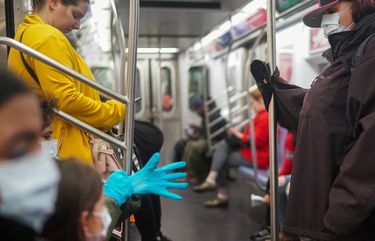 FILE — Subway riders, some using personal protective equipment like masks and gloves, in New York, March 17, 2020. The Centers for Disease Control and Prevention drafted a sweeping order in September requiring all passengers and employees to wear masks on all forms of public and commercial transportation in the U.S., but it was blocked by the White House, according to two federal health officials. (Chang W. Lee/The New York Times) XNYT123