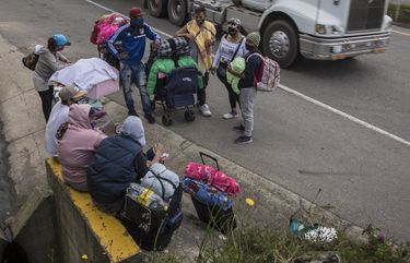 Venezuelan migrants take a rest as they walk towards Bogota, in Tunja, Colombia, Tuesday, Oct. 6, 2020. Thousands of Venezuelans are heading to Colombia, Ecuador, and Peru in search of work as these countries reopen their economies following months of lockdowns. (AP Photo/Ivan Valencia) OTKCOFV102 OTKCOFV102