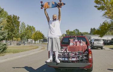 This Oct. 6, 2020 photo released by Ocean Spray shows  Nathan Apodaca holding his skateboard while standing in the back of a truck with Ocean Spray products in Idaho Falls, Idaho. Apodaca is enjoying fame from a 22-second TikTok video in which he chugs cranberry juice and sings along to Fleetwood Macâ€™s â€œDreamsâ€ while cruising down an Idaho highway atop a longboard. The video has racked up 28 million views and counting since he posted it last month. Ocean Spray, whose juice Apodaca is seen swigging in the video, gave him a new truck stocked with juice this week. (Wesley White/Ocean Spray via AP) NYET535 NYET535