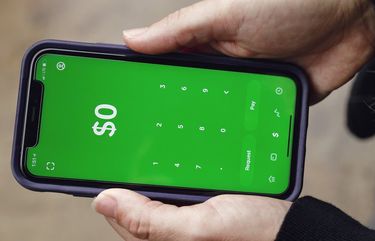 Ashley Tolley opens the Cash App in Travelers Rest, S.C., Sept. 29. (Melissa Golden/The New York Times) 