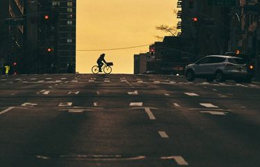 FILE – A cyclist crosses a street in New York, March 24, 2020. With more Americans riding bikes, there’s new pressure to find ways to make the streets safer for everyone. (Bryan Derballa/The New York Times) XNYT99