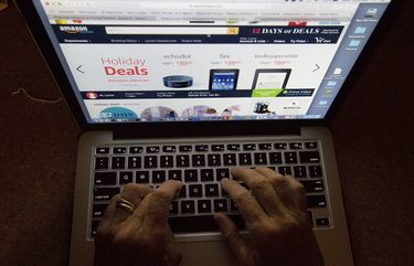 FILE – In this Monday, Dec. 12, 2016, file photo, an online shopper searches Amazon’s website showing holiday deals. With Christmas on a Monday, most retailers have one less day to get packages delivered on time. Retailers have been trying to speed up delivery as they try to replicate the service offered by Amazon. (AP Photo/Wilfredo Lee, File) NYBZ506