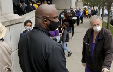 Jamaal Bowman, center, the Democratic nominee running in the 16th congressional district race, stands in line to vote on the first day of early voting, Saturday, Oct. 24, 2020, in Yonkers, N.Y. (AP Photo/Julie Jacobson) NYJJ101 NYJJ101