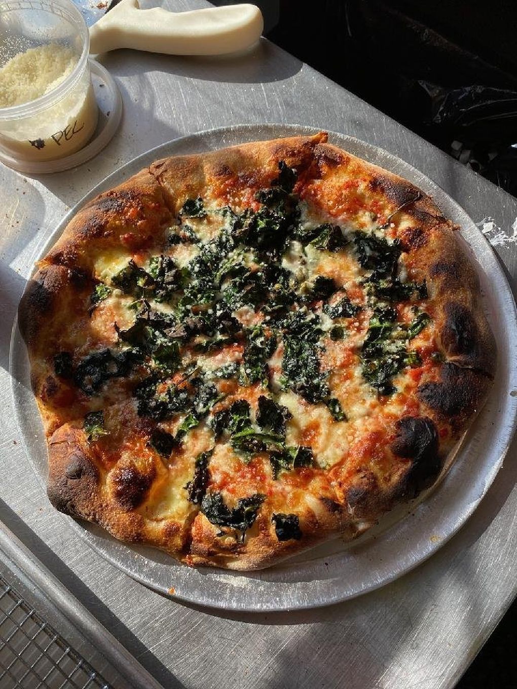 This pizza from Blotto is decorated with spinach and its puffy crust is marked with oven spots.
(Courtesy of Blotto)