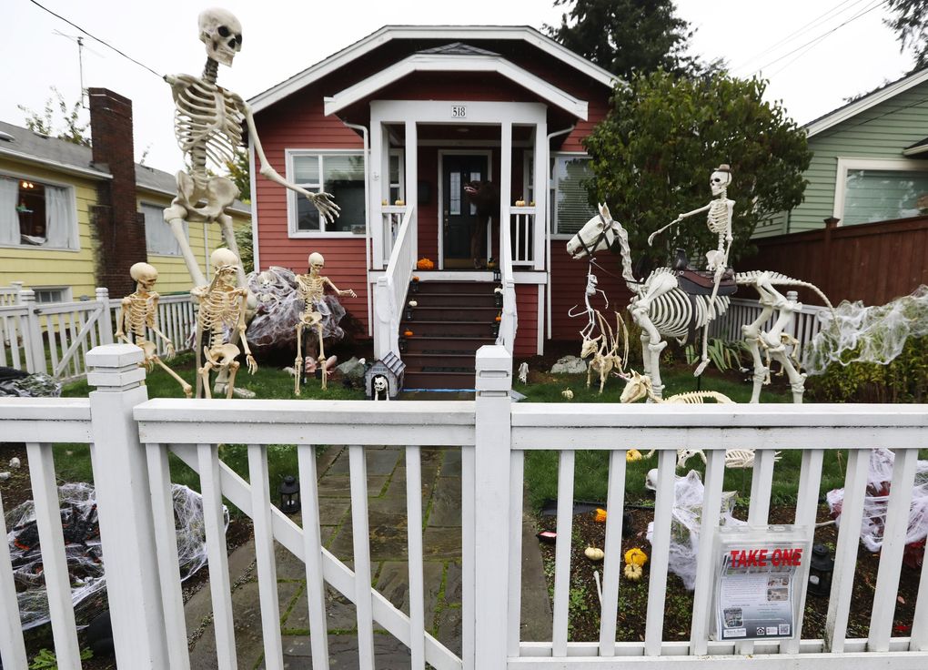 The Halloween scare is out at Seattle homes, including this one in Greenwood, where the front yard was packed with decorations recently. (Ken Lambert / The Seattle Times)