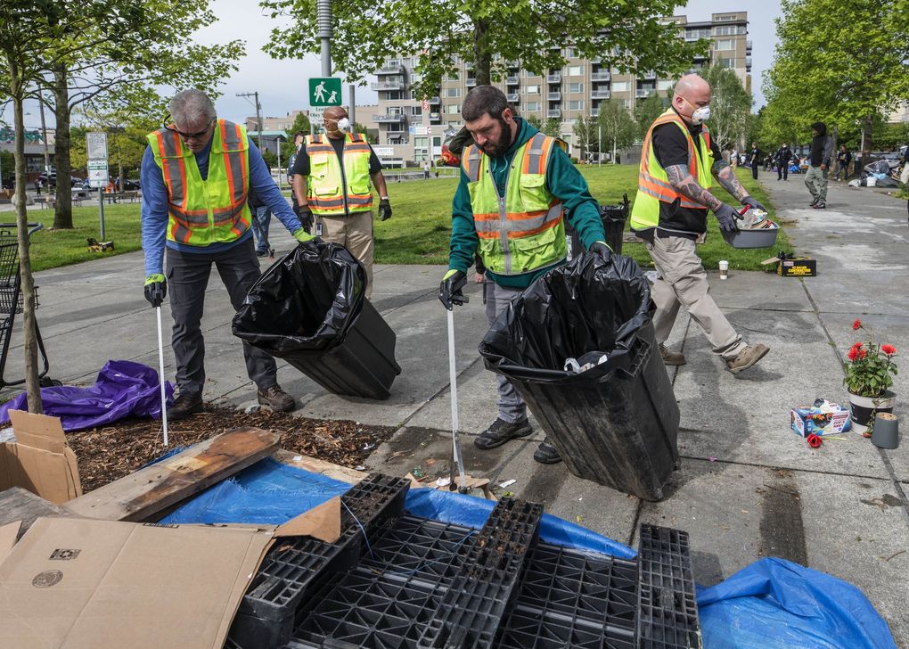 After giving campers at the Ballard Commons a deadline for moving, the Navigation Team started clearing away what some left behind. (Steve Ringman / The Seattle Times)