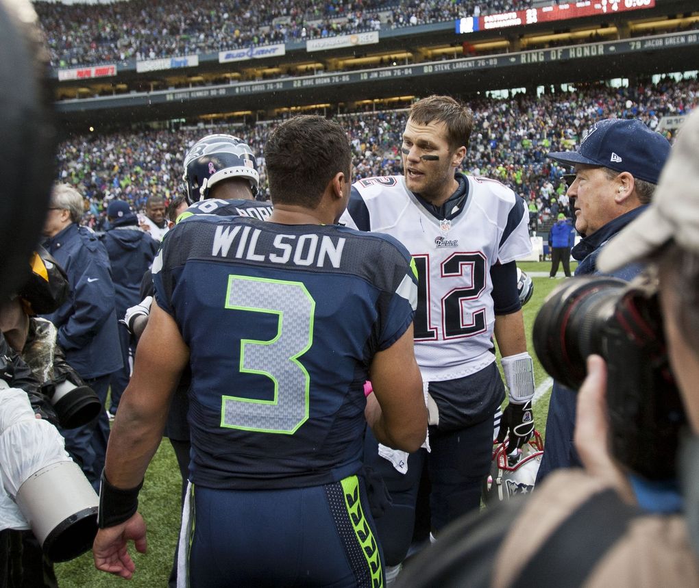 Quarterbacks Russell Wilson of Seattle and Tom Brady of New England meet midfield following the Seahawks’ 24-23 come-from-behind win over the Patriots in 2012. (Dean Rutz / The Seattle Times)