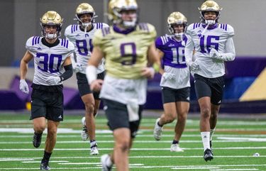 Quarterback Dylan Morris leads a group of receivers including David Pritchard (30), Ty Jones (88) and Rome Odunze (16) as the University of Washington Huskies practice at the Dempsey Center field on October 23, 2020.  215468