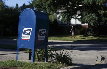 A USPS mail collection box sits on a corner near Boston Edison and Woodward Village in Detroit. (Photo for The Washington Post by Elaine Cromie).