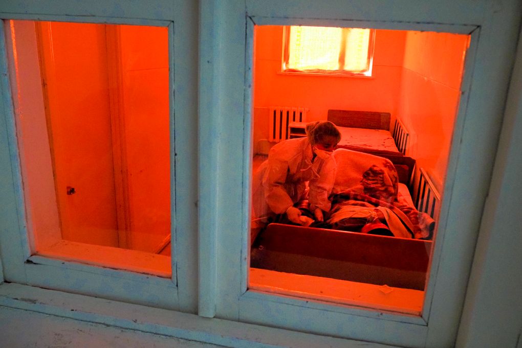 A medic cares for a coronavirus patient in an infectious diseases clinic in Stepanakert, the separatist region of Nagorno-Karabakh, Tuesday, Oct. 20, 2020. Nagorno-Karabakh, which lies within Azerbaijan but has been under the control of ethnic Armenian forces since a war there ended in 1994, faces an outbreak of the coronavirus amid the largest outbreak of hostilities in more than a quarter-century. (AP Photo)