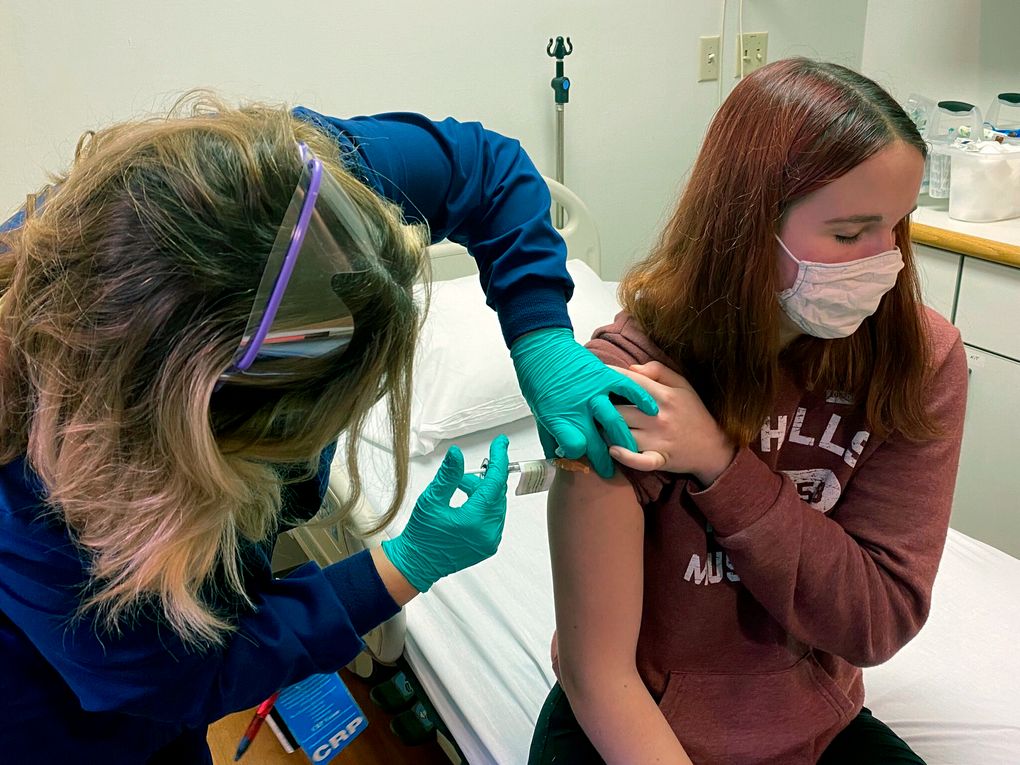 Clinical research coordinator Tammy Lewis-McCauley administers an injection to Katelyn Evans as part of a clinical trial of Pfizer’s COVID-19 vaccine at Cincinnati Children’s Hospital Medical Center. (Cincinnati Children’s Hospital Medical Center via AP)