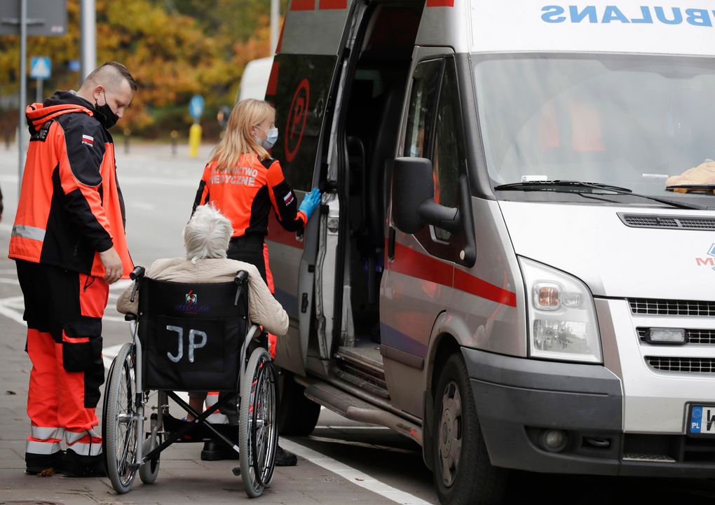 An ambulance brings a COVID-19 patient to a specialized hospital in Warsaw, Poland, on Tuesday, Oct. 20, 2020. Poland is seeing a sharp spike in new cases daily of coronavirus infections, filling up hospital beds. Poland’s government is transforming the National Stadium in Warsaw into a field hospital to handle the surging number of people infected with the coronavirus, and expects it to be operational within days, officials said. (AP Photo/Czarek Sokolowski)