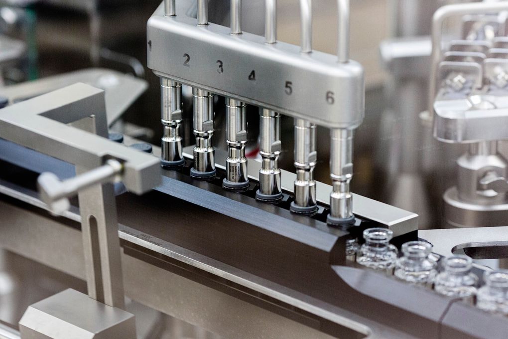 FILE – In this March 2020 photo provided by Gilead Sciences, rubber stoppers are placed onto filled vials of the investigational drug remdesivir at a Gilead manufacturing site in the United States. Given through an IV, the medication is designed to interfere with an enzyme that reproduces viral genetic material. (Gilead Sciences via AP)