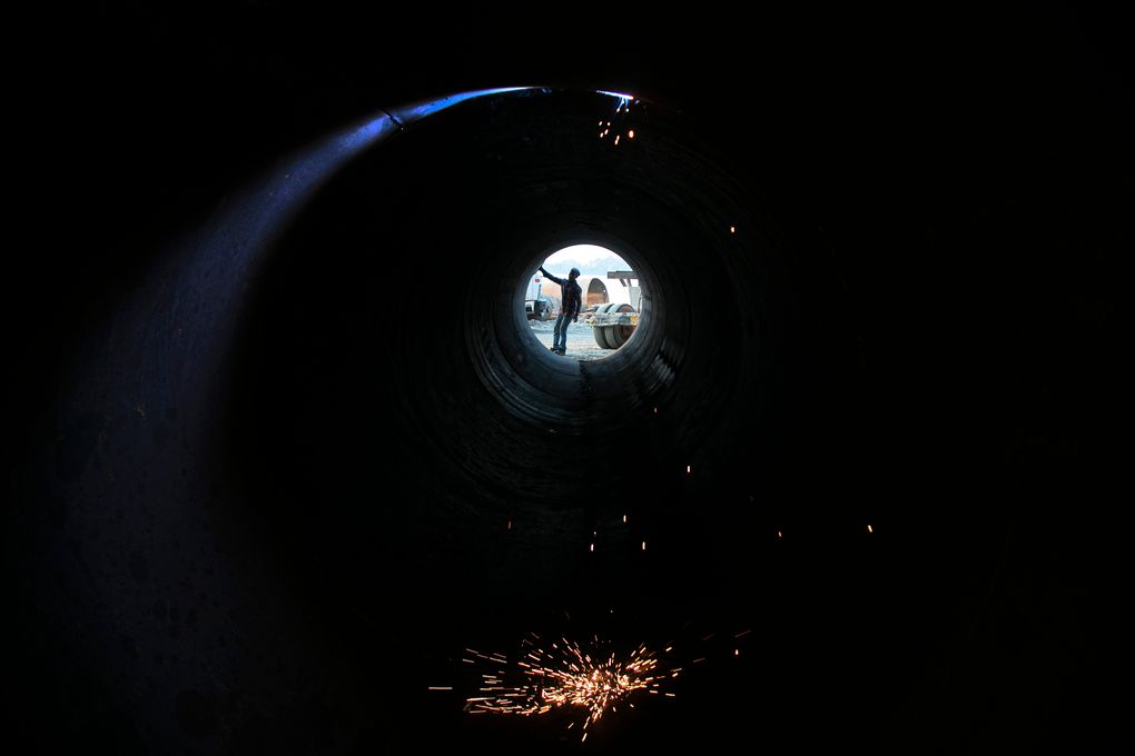 An Indian laborer works near a bridge construction site along the river Brahmaputra in Gauhati, India, Monday, Oct. 12, 2020. (AP Photo/Anupam Nath)