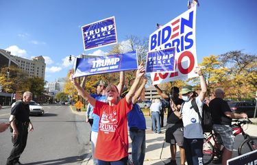 President Donald Trump supporters and Democratic presidential candidate Joe Biden supporters square off in front of Penn Place office building in Wilkes-Barre, Pa., Thursday, Oct. 22, 2020. The Luzerne County Election Bureau is located inside Penn Place where early walk-in voting has started. (Mark Moran/The Citizens’ Voice via AP)