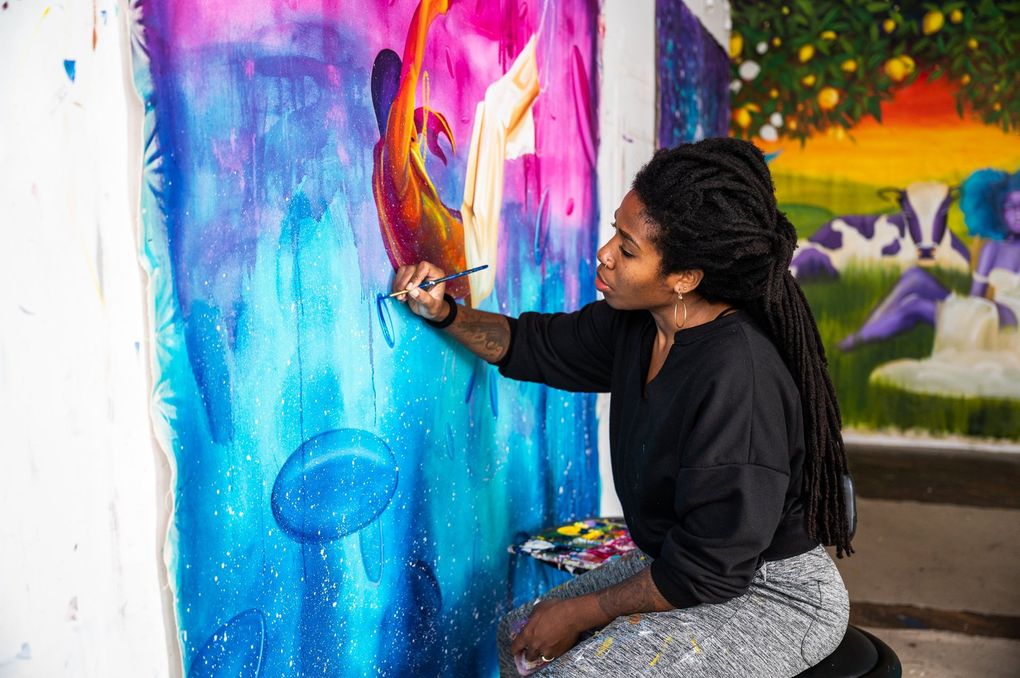 Aramis O. Hamer completes paintings to be installed at the Bellevue Arts Museum’s “Yellow No. 5” exhibit. (Emilie Smith)