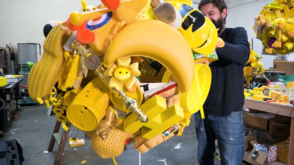 Ben Beres of the Seattle-based art collective SuttonBeresCuller works on part of the trio’s installation for Bellevue Arts Museum’s “Yellow No. 5,” curated by Tariqa Waters. (Emilie Smith)