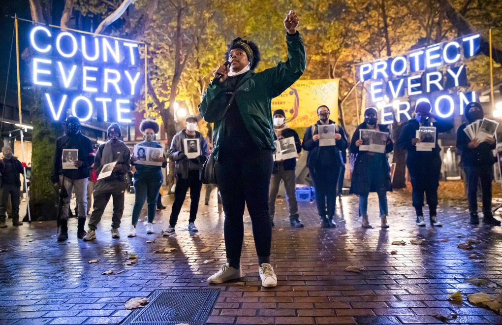 Travonna Thompson-Wiley, with Black Action Coalition, speaks at the ‘Count Every Vote – Protect Every Person’ rally and march in Seattle’s Occidental Park on Wednesday. “Now is the new normal, and we want Black liberation, and also we want Native sovereignty,” Thompson-Wiley says. A coalition of groups organized the event, which drew hundreds of people. The coalition demanded that every vote be counted and that there be orderly transition of power. (Erika Schultz / The Seattle Times)