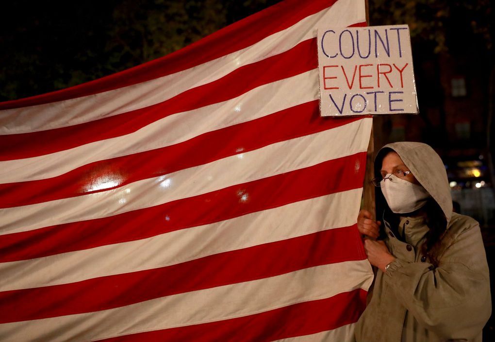 Debbie Douglas, a Seattle resident, attends the ‘Count Every Vote – Protect Every Person’ rally and march in Occidental Park in Seattle on Wednesday. (Erika Schultz / The Seattle Times)