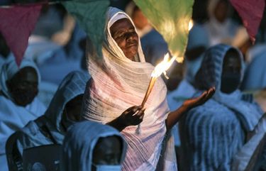 Ethiopian Orthodox Christians light candles and pray for peace during a church service at the Medhane Alem Cathedral in the Bole Medhanealem area of the capital Addis Ababa, Ethiopia Thursday, Nov. 5, 2020. Ethiopia’s powerful Tigray region asserts that fighter jets have bombed locations around its capital, Mekele, aiming to force the region “into submission,” while Ethiopia’s army says it has been forced into an “unexpected and aimless war.” (AP Photo/Mulugeta Ayene) NAI106 NAI106