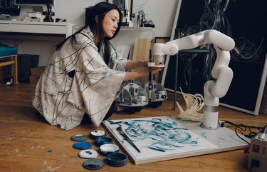 Artist Sougwen Chung works in her Brooklyn studio. MUST CREDIT: Photo for The Washington Post by Celeste Sloman