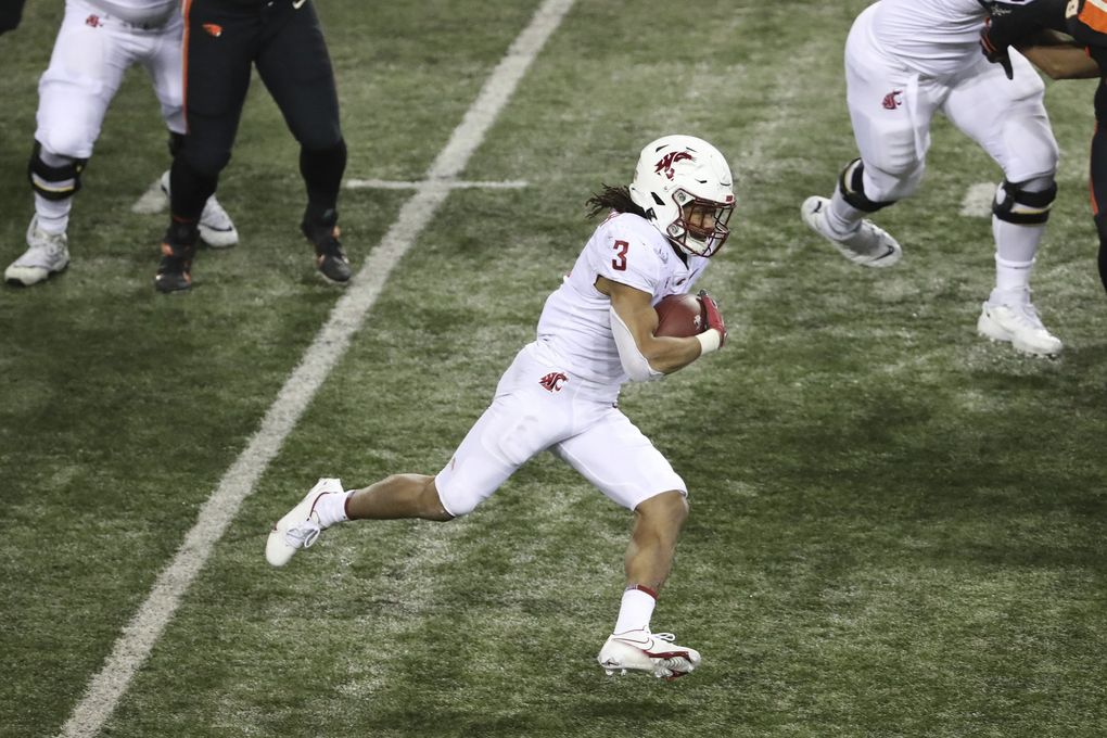 Washington State running back Deon McIntosh carries during the first half Saturday.(Amanda Loman / The Associated Press)