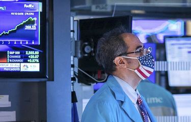 In this photo provided by the New York Stock Exchange, specialist Jorge Fernandez works at his post on the trading floor, Wednesday Nov. 11, 2020. Another rally for the S&P 500 on Wednesday is sending it to the edge of its record high, and this time big technology stocks are also rising on Wall Street. (Courtney Crow/New York Stock Exchange via AP) NYRD307 NYRD307