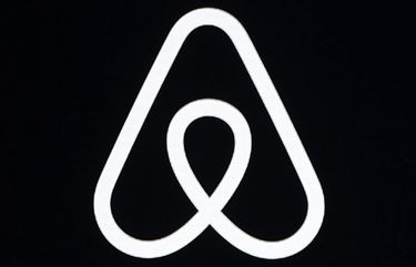 FILE – This Feb. 22, 2018, file photo shows an Airbnb logo during an event in San Francisco. Airbnb was losing money even before the pandemic struck and cut its revenue by almost a third, the home-sharing company revealed in documents filed Monday, Nov. 16, 2020, ahead of a planned initial public offering of its stock. (AP Photo/Eric Risberg, File) NYSB102