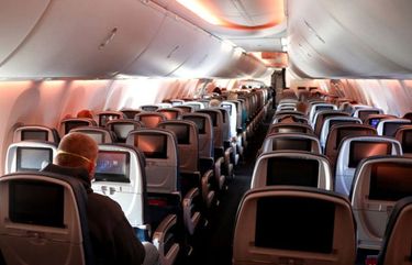 Passengers are seen in a cabin mid-flight on a Baltimore-bound Delta flight from Hartsfield-Jackson Atlanta International Airport on April 20, 2020, in Atlanta. (Rob Carr/Getty Images/TNS) 1839893 1839893