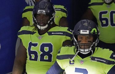 Seattle Seahawks guard Damien Lewis, left, celebrates with head coach Pete  Carroll after the team scored during the first half of an NFL football game  against the Arizona Cardinals in Glendale, Ariz.