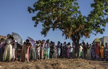 Tigray refugee women who fled the conflict in Ethiopia’s Tigray region, wait in line to receive dignity kits at Umm Rakouba refugee camp in Qadarif, eastern Sudan, Tuesday, Nov. 24, 2020. (AP Photo/Nariman El-Mofty) NM103 NM103
