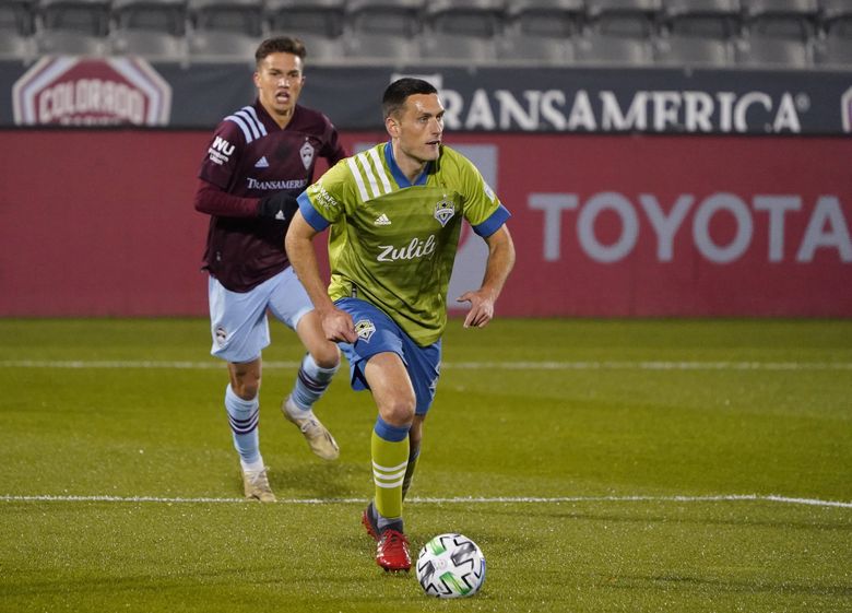 Sounders defender Shane O’Neill, front, looks to pass the ball as Rapids midfielder Cole Bassett pursues in the first half of a game on Nov. 1 2020, in Commerce City, Colo. (AP Photo/David Zalubowski) 