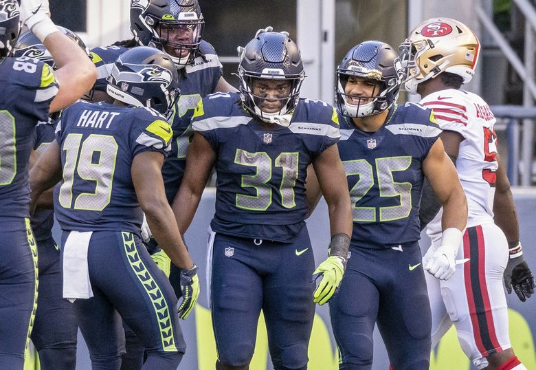 Seattle Seahawks running back DeeJay Dallas celebrates after