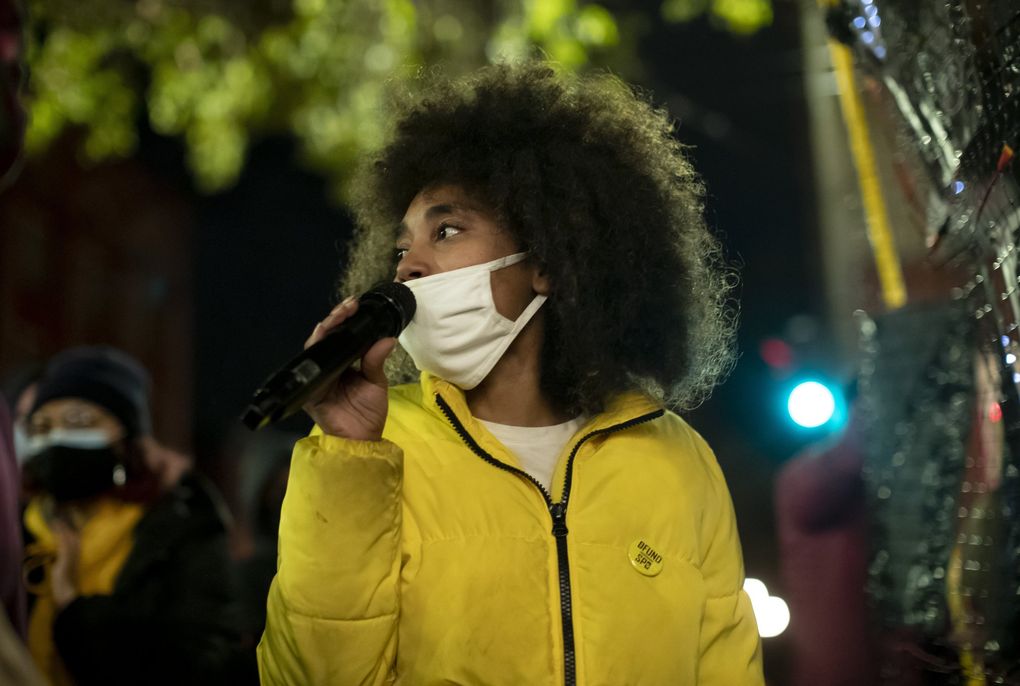 Katie N., an organizer with the Morning March, speaks at the “Count Every Vote – Protect Every Person” rally and march in Occidental Park on Wednesday. (Erika Schultz / The Seattle Times)