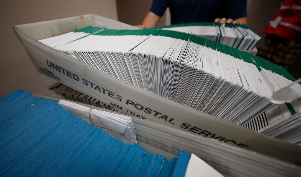 Utah County election workers stack ballots to be processed and picked up at a U.S. Postal Service office on Oct. 26 in Provo. On Tuesday, a federal judge ordered the U.S. Postal Service to immediately sweep facilities in several crucial swing states to locate any mail-in ballots and send them to election officials.(George Frey / Getty Images)